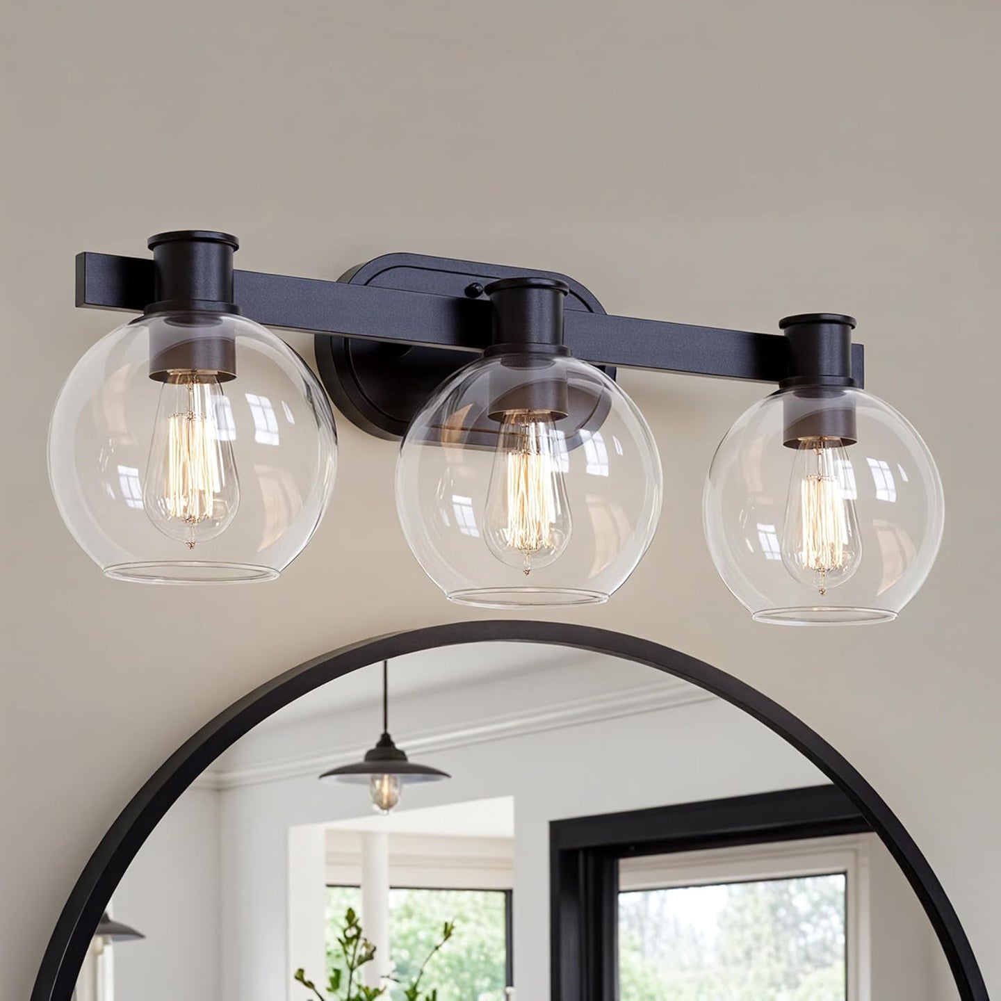 Matte black Dan 3-light bathroom vanity light installed and lit