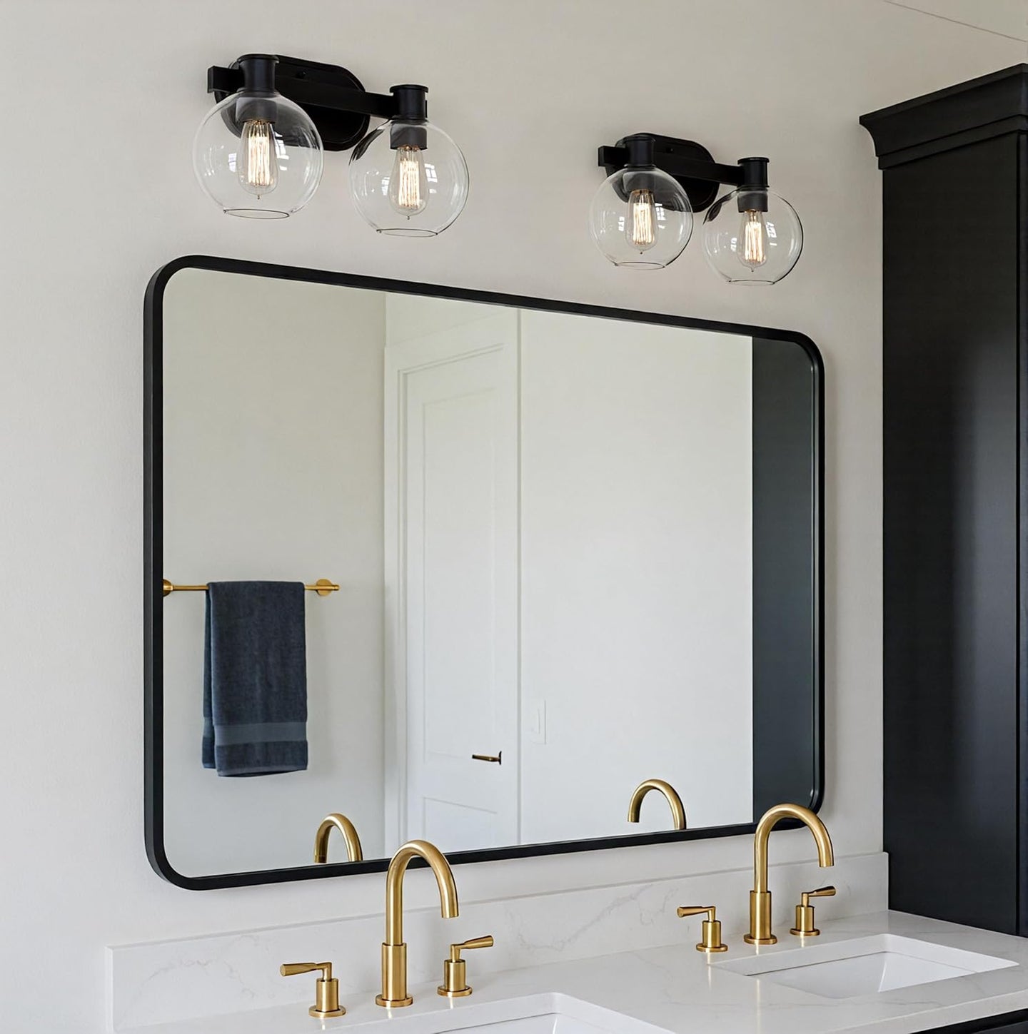 Dan 2-light bathroom vanity light installed and lit above a bathroom mirror